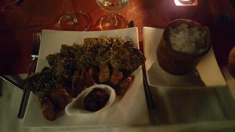 Traditional Laotian pork sausage, riverweed, chili paste and sticky rice at the Victoria Palace Hotel in Luand Prabang.