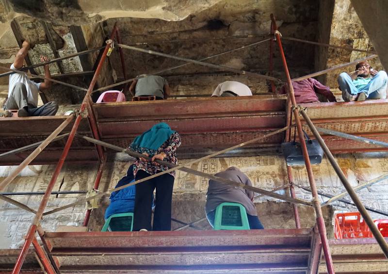 Working on cleaning the Roman frescoes inside the Temple of Luxor